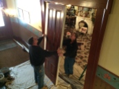 Parlor pocket doors being removed from the wall for the first time in more than 100 years.